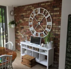 large clock on brick wall